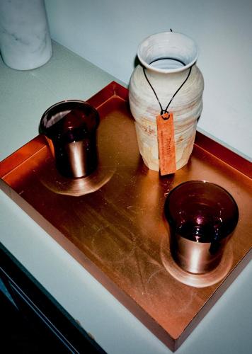 a counter with two bowls and a vase on it at Hart Shoreditch Hotel London, Curio Collection by Hilton in London