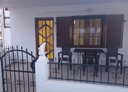 a balcony of a house with chairs and a window at Erasmio Studio in Xanthi