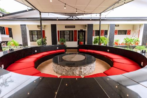 a room with a table with a tree stump in it at Blue Veil Villa Hotel in Kigali