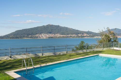 a swimming pool with a view of the water at GuestReady - Countryside dream in Caminha in Caminha