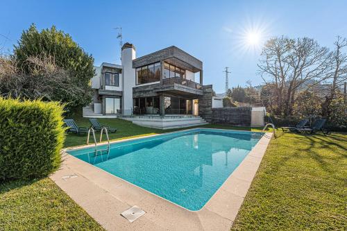 a house with a swimming pool in front of a house at GuestReady - Countryside dream in Caminha in Caminha