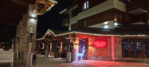 a building with a sign on the front of it at Bansko Pirin Golf & Country Club Blue Mountains View in Razlog