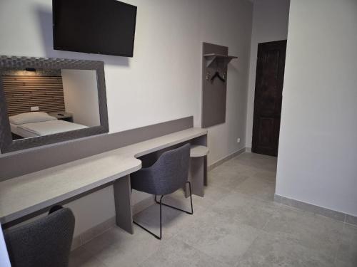a room with a vanity with a mirror and a bed at Marcus in Bydgoszcz