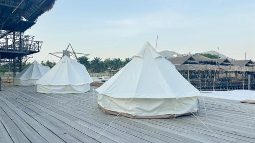 a group of three tents on a wooden deck at Thailand Mountain Phuket in Patong Beach