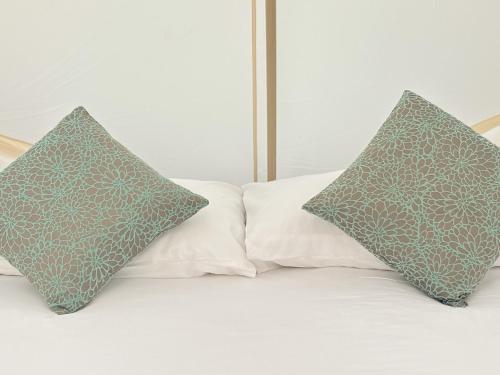 two pillows sitting on top of a bed at Thailand Mountain Phuket in Patong Beach