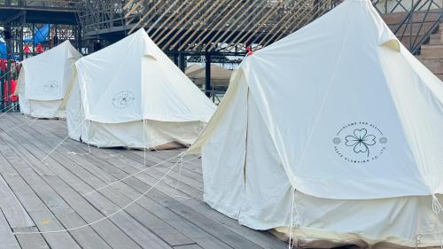a row of white tents sitting on a deck at Thailand Mountain Phuket in Patong Beach