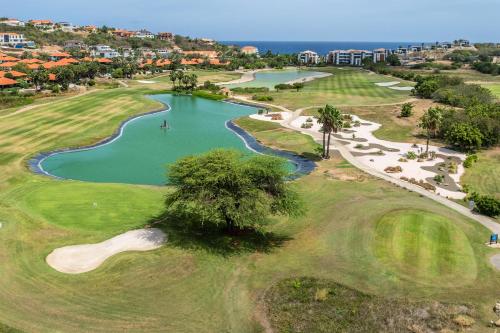 an overhead view of a golf course with a pond at NEW! The Jazmyn at Blue Bay Golf & Beach Resort in Sint Michiel