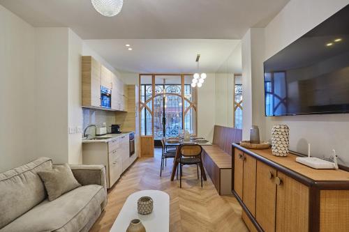 une cuisine et un salon avec un canapé et une table dans l'établissement Sublime air-conditioned apartment Center of Paris, à Paris