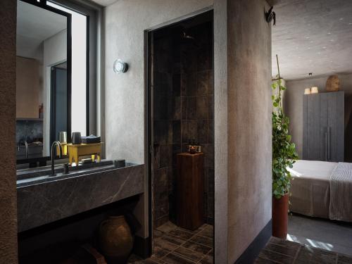 a bathroom with a sink and a mirror at Monastik Living in Athina in Athens
