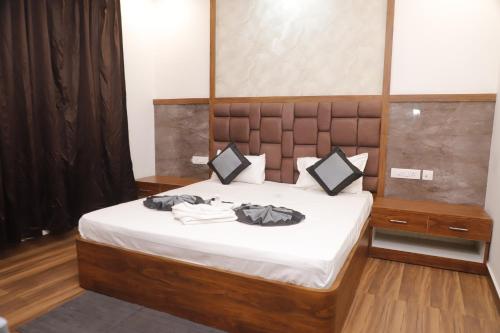 a bedroom with a bed with clothes on it at The Blessing Palace in Muzaffarpur