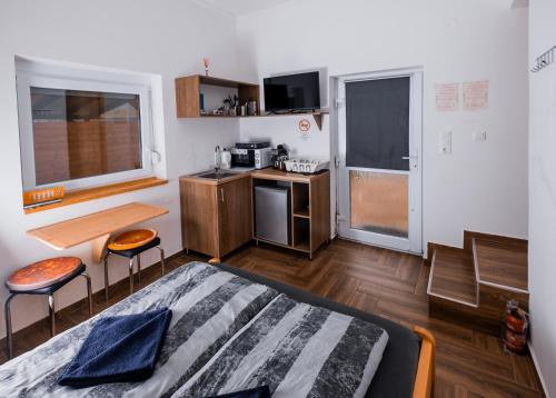 a small room with a bed and two chairs in it at Chill House in Orfű