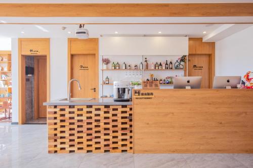 a kitchen with two laptops on a counter at Poetlake hotel-LuguLake Lijiang in Zuosuo