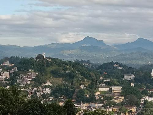 a view of a city with mountains in the background at Namadi heights Bungalow in Kandy
