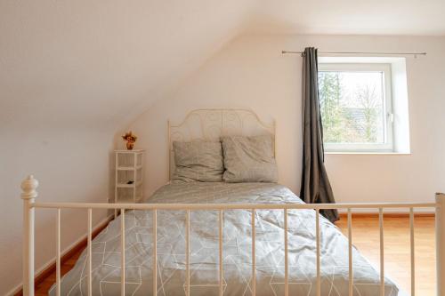 a bedroom with a bed and a window at Sleep two Fly in Hamburg