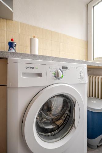 a white washing machine sitting in a kitchen at Sleep two Fly in Hamburg