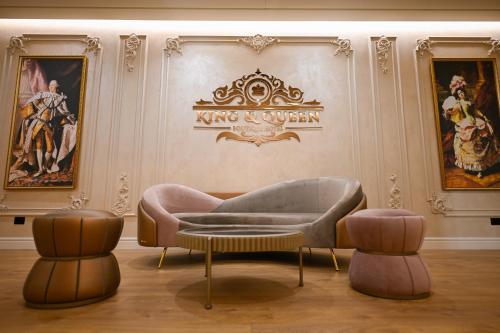 a living room with a couch and two chairs at King & Queen Boutique Hotel in Fier