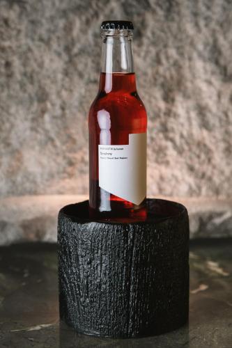 a bottle of sauce sitting on top of a block at Monastik Living in Athina in Athens