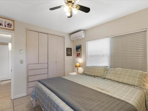 a bedroom with a bed and a ceiling fan at Holiday Isle Yacht Club in Fort Lauderdale