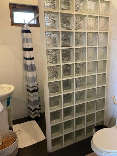 a bathroom with a toilet and a shower curtain at Thailand Dream Village E09 in Klaeng