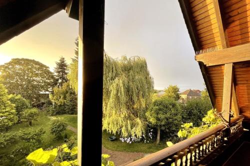 a window view of a tree from a house at Exklusive Landvilla mit Pool, Sauna und Garten in Schwalmtal