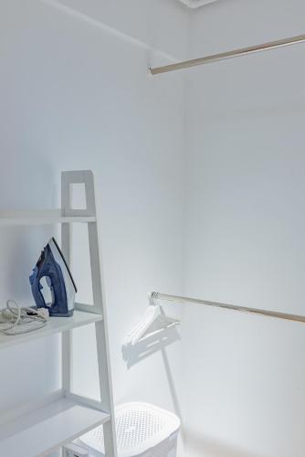 a white shelf in a room with a lamp at Lady-s View in Floreşti