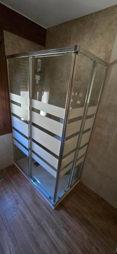 a glass elevator in a room with a wooden floor at El Mirador de Tanes in Tanes