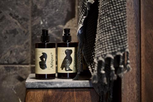 two bottles of essential oils sitting on a shelf at Monastik Living in Athina in Athens
