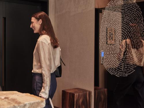 a woman standing in front of a mirror at Monastik Living in Athina in Athens
