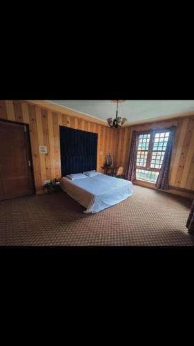 a bedroom with a large bed in a room at Busybee Guest House in Srinagar