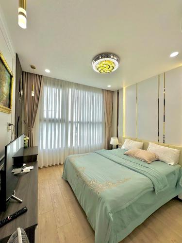 a bedroom with a large bed and a television at Luxury Apartment with beautiful view in Hanoi