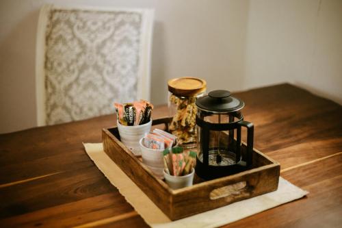 a wooden tray with a coffee maker on a table at 62 on Adderley in George