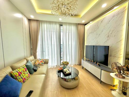a living room with a couch and a flat screen tv at Luxury Apartment with beautiful view in Hanoi