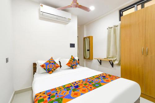a bedroom with a bed and a ceiling fan at FabHotel Elegance - Nr US Consulate, Financial District in Hyderabad