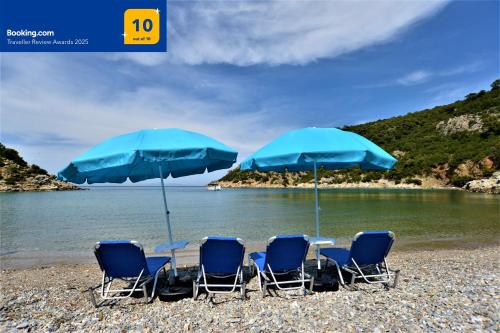 a group of chairs and umbrellas on a beach at Private Beach House Irene Mare in Poros