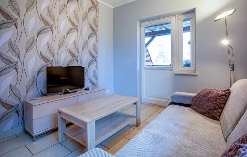 a living room with a tv and a couch at Stunning Apartment In Gdansk With Wifi in Gdańsk