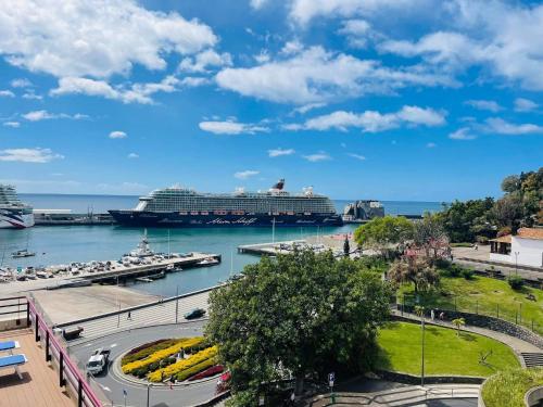 a cruise ship is docked in a harbor at Center Marina view Gold Studio in Funchal