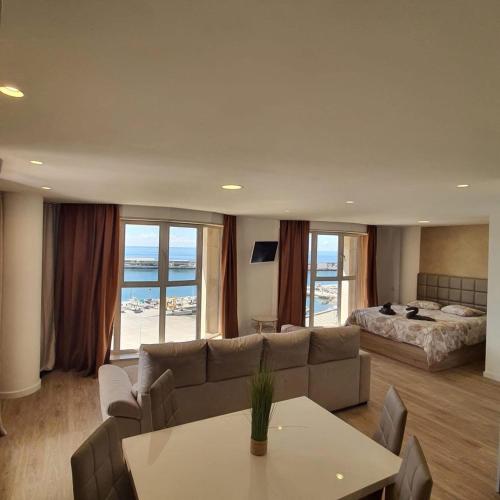 a living room with a couch and a bed at Center Marina view Gold Studio in Funchal