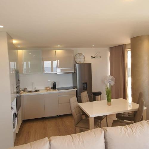 a living room and kitchen with a table and a couch at Center Marina view Gold Studio in Funchal
