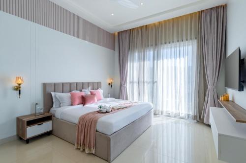 a bedroom with a large bed with pink pillows at ELIVAAS Shourya Sereno - Luxe 4 BHK Villa With Pvt Pool & Garden in Lakāwās