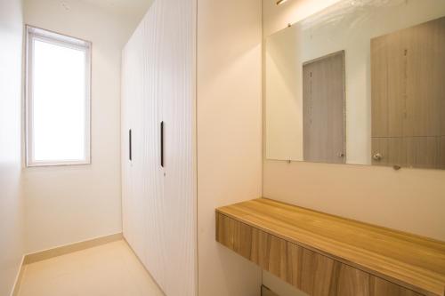 a bathroom with a wooden counter and a mirror at ELIVAAS Shourya Sereno - Luxe 4 BHK Villa With Pvt Pool & Garden in Lakāwās