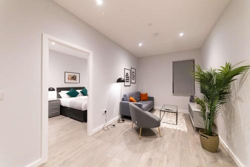 a bedroom with a bed and a couch and a chair at Convenient 2 Bed Apartment in Waterloo Liverpool in Waterloo