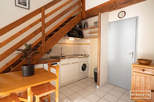 une petite cuisine avec un escalier dans une maison dans l'établissement Maison de vacances à 600m de la plage, à Vias