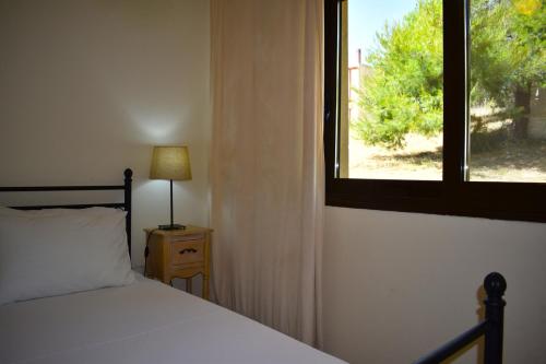 a bedroom with a bed and a window at Kripis Studio Paliouri in Paliouri