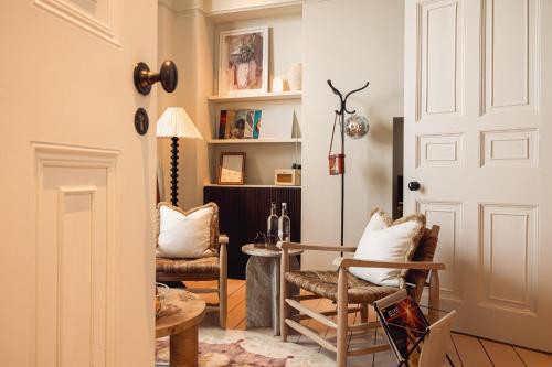 a room with two chairs and a table and a door at No.124 by GuestHouse, Brighton in Brighton & Hove