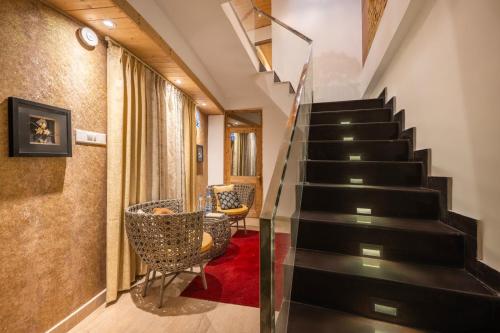 a staircase in a house with a glass stair case at Anastasia in Shimla