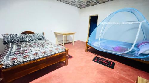a bedroom with a bed and a tent at Sigiri Elephants Path Hostel in Kibissa