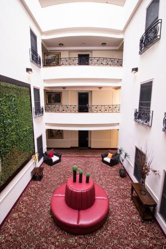 a large room with a red table in the middle at Hotel Ticuán in Tijuana