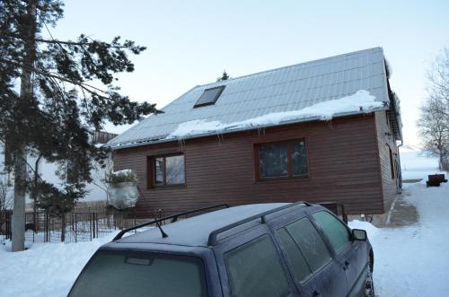 a car parked in front of a house in the snow at Mária Kičáková TATRY MKS in Štrba