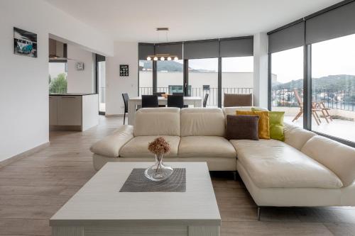a living room with a white couch and a table at Korcula Luxury Apartments in Korčula