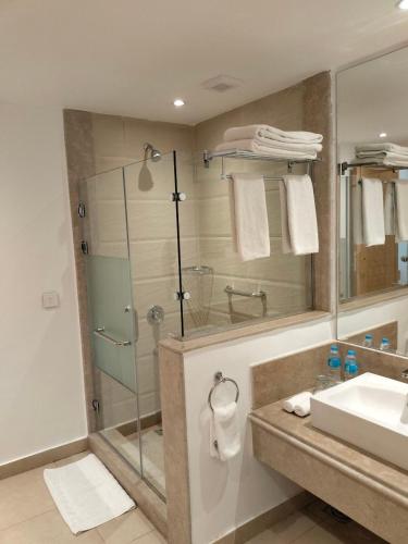a bathroom with a glass shower and a sink at Tamra Beach Resort in Sharm El Sheikh